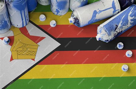 Premium Photo | Zimbabwe flag and few used aerosol spray cans for ...