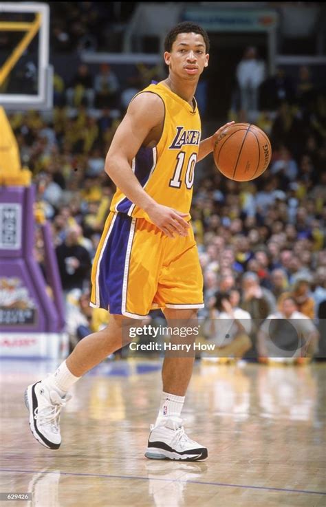 Tyronn Lue of the Los Angeles Lakers dribbles the ball down the court ...