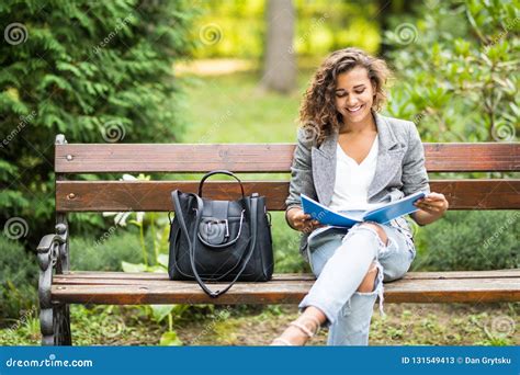 The Girl Sitting on a Bench, Reading a Book Stock Image - Image of life ...