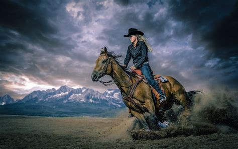 Dynamic Cowgirl: HD Wallpaper of Horse Riding Adventure