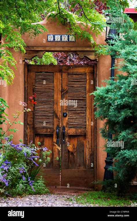 Santa Fe style wooden doors entrance Stock Photo - Alamy