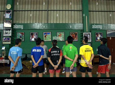 Young badminton players are given instructions during a training ...