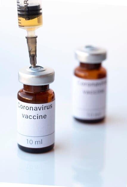 Premium Photo | The photo illustration shows two vials labeled coronavirus vaccine and syringe