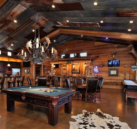 Rustic Game Room with Concrete floors, Carpet, Exposed beam, Cathedral ceiling, Chandelier ...