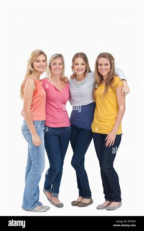 Full length of four girls standing beside each other and smiling Stock Photo - Alamy