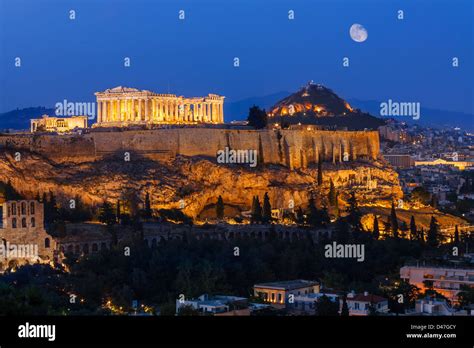 Parthenon on Acropolis Hill of Athens by night with moon in the sky Stock Photo - Alamy