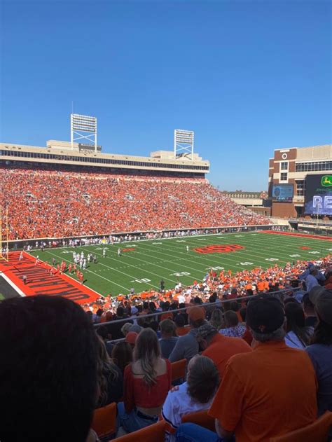 an orange and white football stadium filled with people sitting on the ...