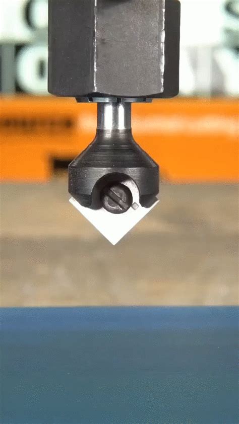 a close up of a machine tool on a piece of metal that has been placed ...