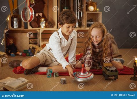 Two Kids Playing with Toys Near the Christmas Tree Stock Image - Image ...