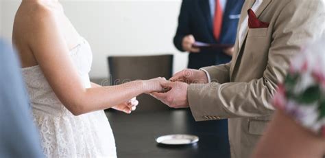 The Groom Wearing Wedding Ring for the Bride Stock Photo - Image of event, groom: 137811592