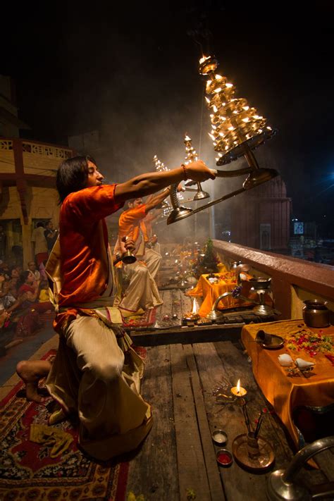 An Hindu priest performing the evening ritual called arati in Varanasi ...