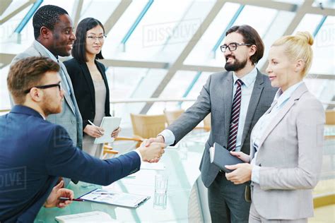 Businessmen shaking hands after successful meeting - Stock Photo - Dissolve