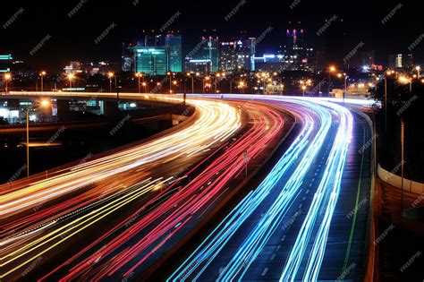 Premium AI Image | a highway at night with traffic lights and buildings in the background