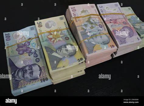 Romanian leu banknotes on a black background Stock Photo - Alamy