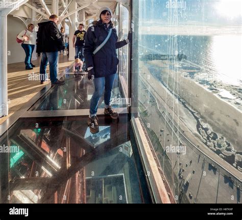 Female tourist on glass floor of Blackpool Tower skywalk, Lancashire ...