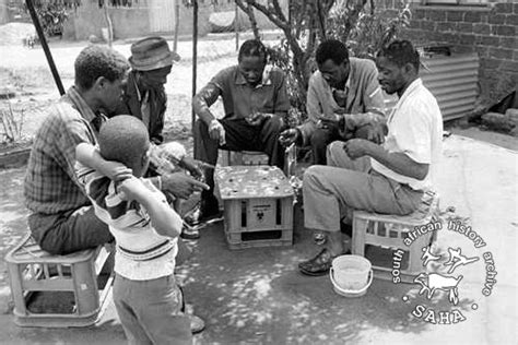 SAHA - South African History Archive - Child watching gamblers in shebeen in Tembisa