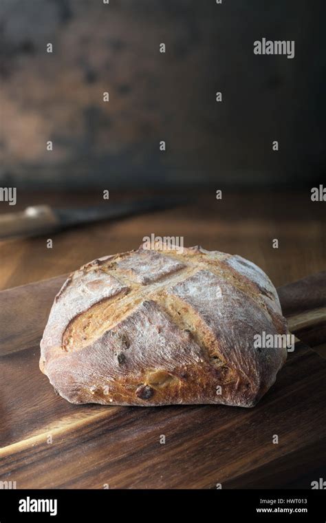 Rustic bread on cutting board Stock Photo - Alamy