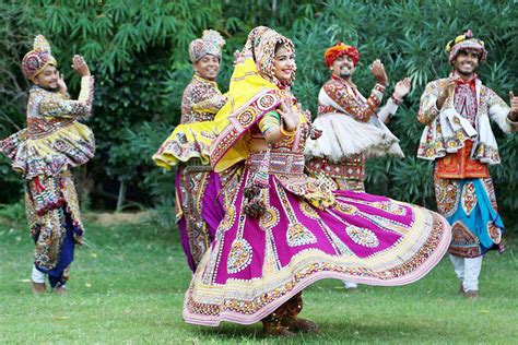 Indian men and women in traditional attire perform Garba, a traditional dance of Gujarat state ...