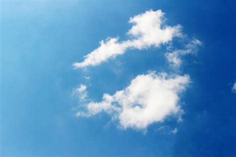 White fluffy clouds in a blue sky 1967674 Stock Photo at Vecteezy