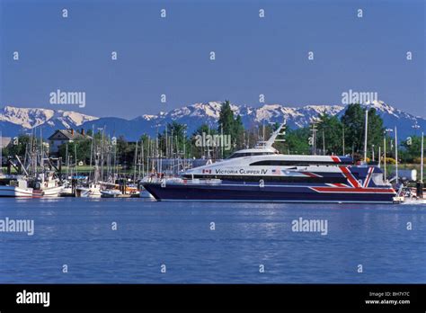 Victoria Clipper passenger ferry enters Victoria harbor, Small boat ...