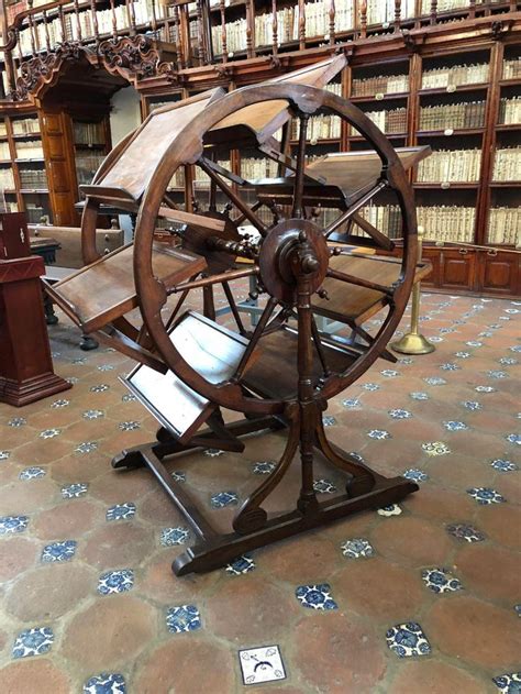 an old spinning wheel in the middle of a library