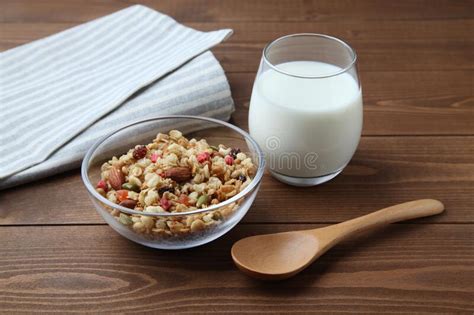 Granola Cereal in Bowl with Milk Isolated on Wooden Table Stock Photo ...