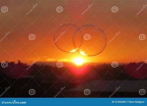 Two bubbles in the sunset stock photo. Image of black - 57432440