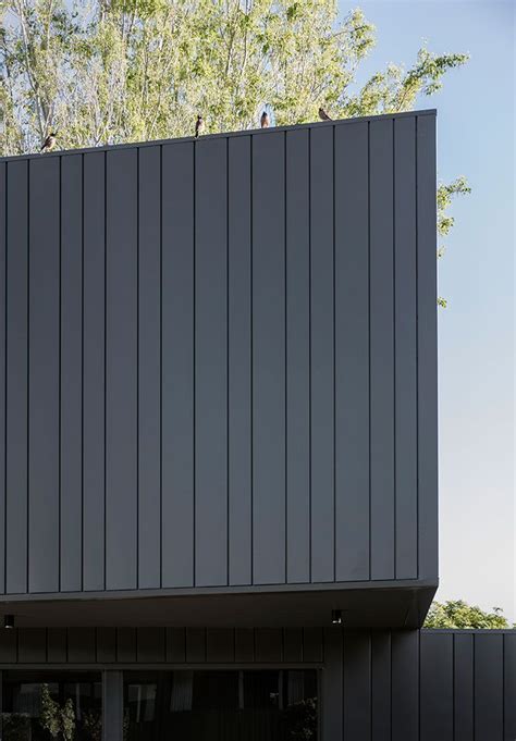 Black metal facade applied in varied thicknesses to add interest and ...