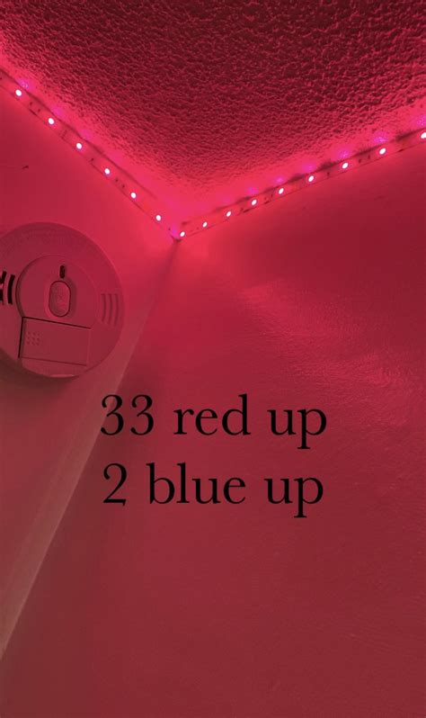 red up 2 blue up lights in a room with pink walls and white ceilinging