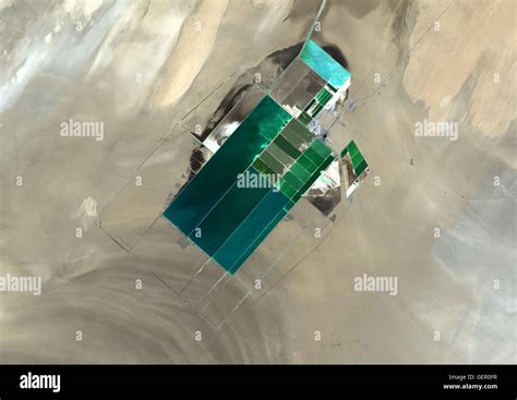 The satellite image shows potash evaporation ponds in Lop Nur, a former salt lake in the ...