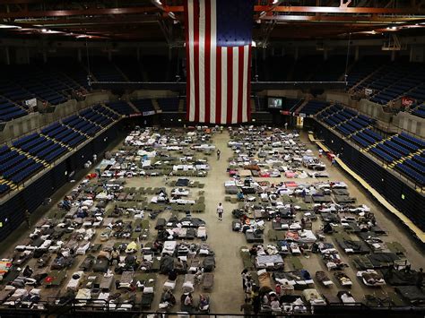 Evacuees seek temporary shelter in The Baton Rouge River Center arena in Baton Rouge, La., on ...