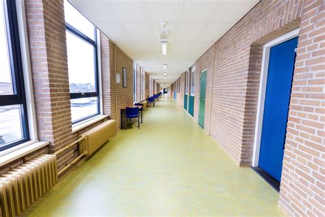 Long empty corridor in high school building - Moore Diversified ...