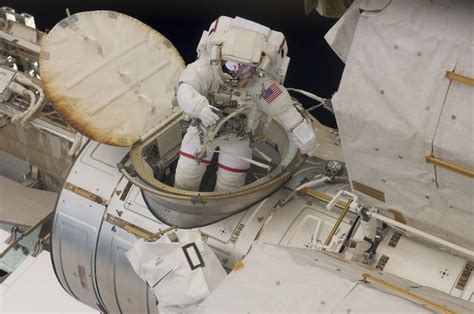 Astronaut ingresses the airlock hatch on the International Space Station Stretched Canvas ...