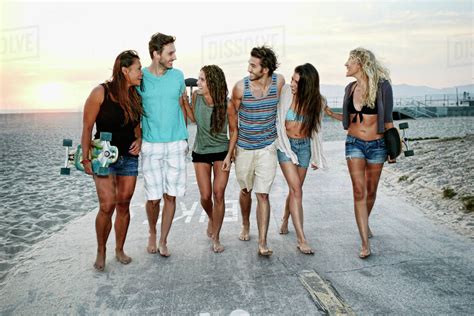 Friends walking together on beach - Stock Photo - Dissolve