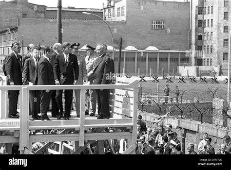 US president John F. Kennedy at a view point at the Berlin wall on 26 June 1963. Right german ...