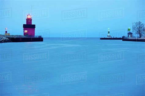 USA, Michigan, Holland, Lighthouse at sunrise - Stock Photo - Dissolve