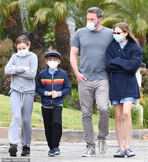 Ben Affleck embraces his daughter Violet as he takes his children for a walk as they wear masks ...