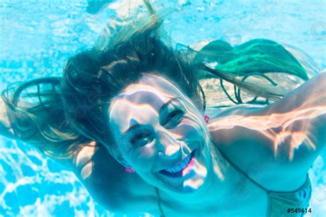 Girl diving underwater in swimming pool - stock photo 549614 | Crushpixel