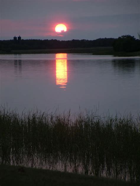 Sunset over the Rainy River. The Rainy River is the natural border between Minnesota and Ontario ...