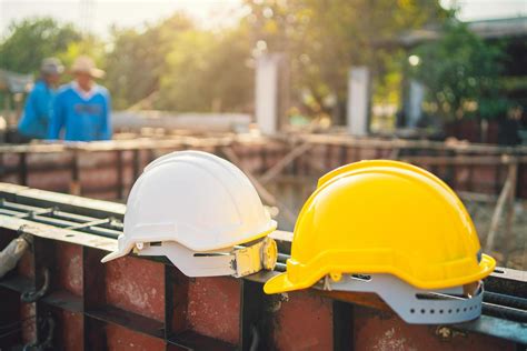 white and yellow helmet on steel in construction site 7449209 Stock Photo at Vecteezy