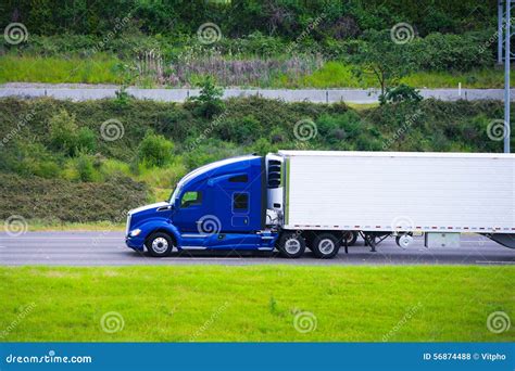 Modern Dark Blue Semi Truck Reefer Trailer Profile On Green Road Stock Photo - Image: 56874488