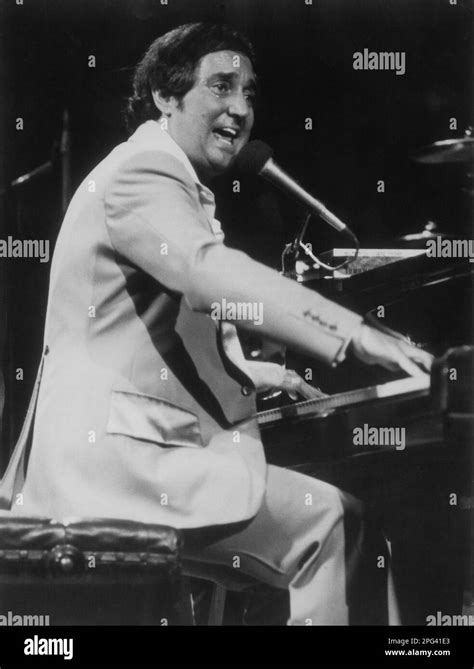 American singer-songwriter and pianist, Neil Sedaka playing piano while performing on stage ...