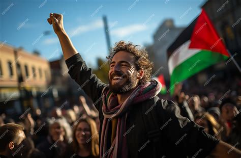 Premium AI Image | A man up a hold waving Palestinian flag to Freedom for Palestine Protest ...