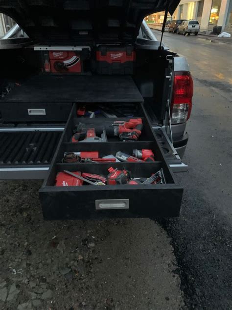 the toolbox is open on the back of the truck, with tools in it