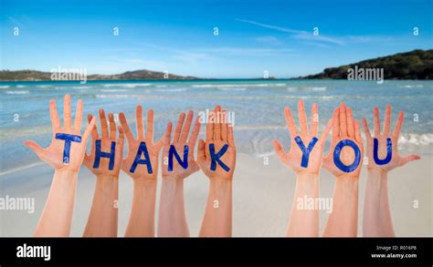 Many Hands Building Word Thank You, Beach And Ocean Stock Photo - Alamy