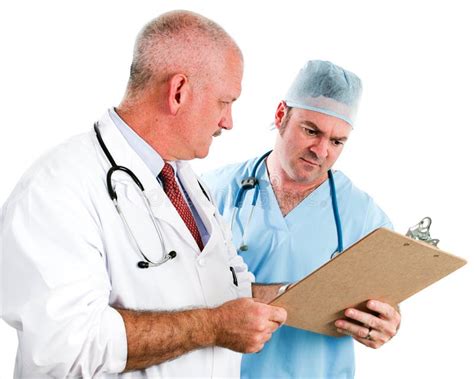 Doctors Review a Chart stock photo. Image of consultation - 1078710