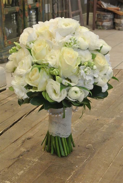 Bridal bouquet with roses, ranunculus, lisianthus, stocks and hydrangea. Designed by Forget-Me ...