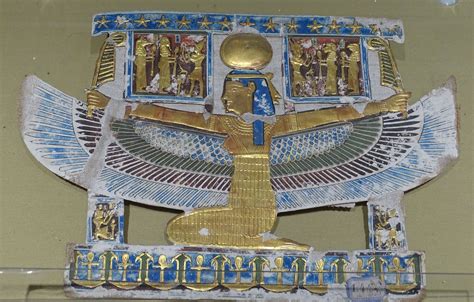 an egyptian style clock with gold and blue decorations