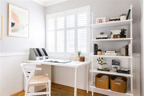 Download A White Home Office With A Chair And Bookshelves | Wallpapers.com