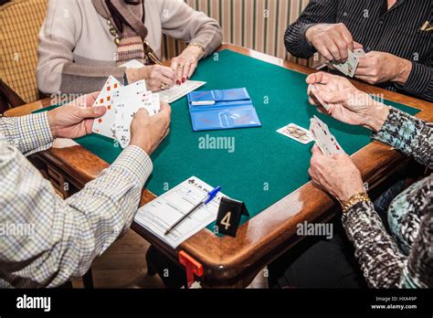 old people playing bridge game Stock Photo - Alamy